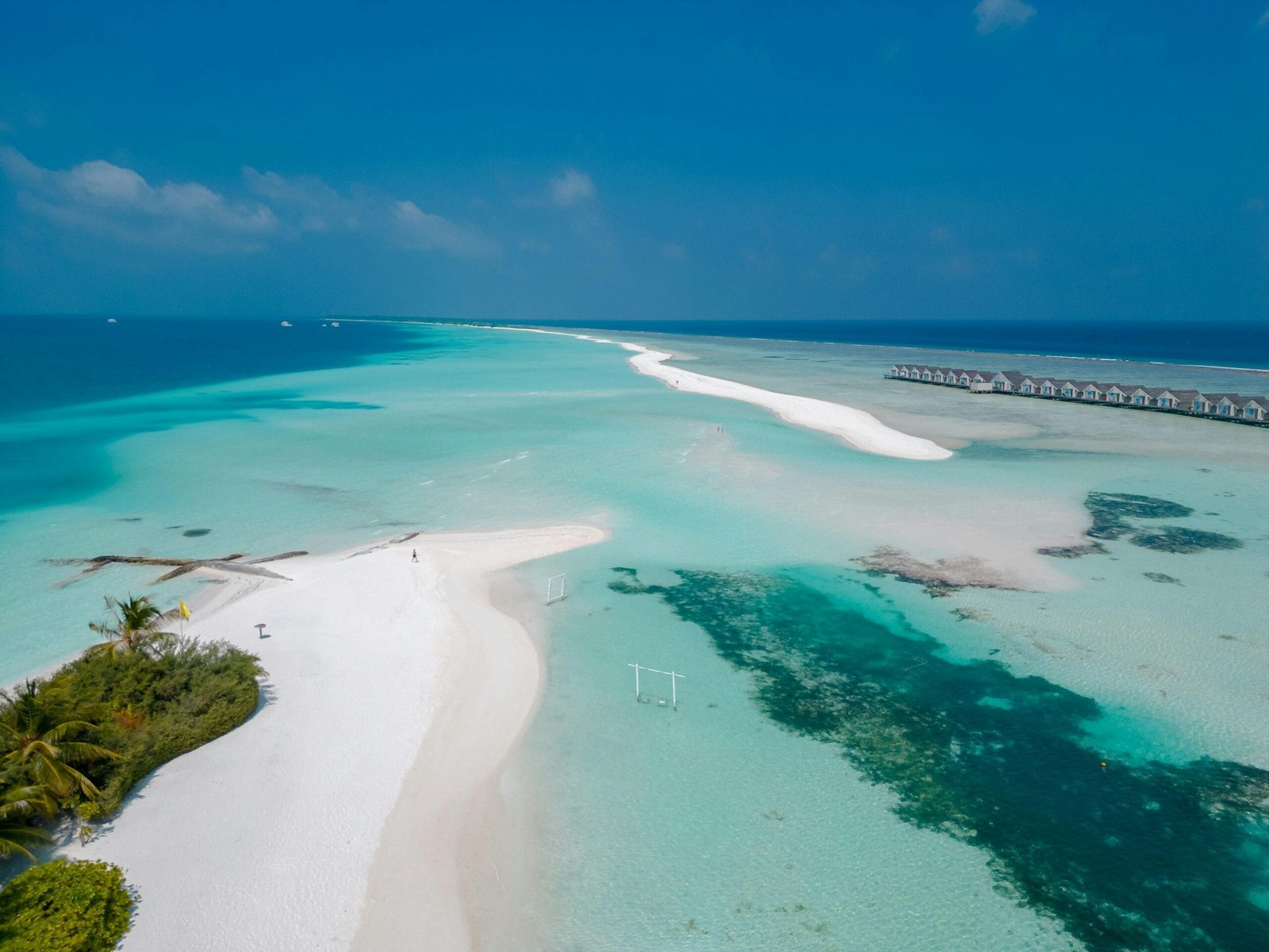 Tropical paradise at Dhigurah Beach, Maldives - pristine white sand and clear blue ocean views.