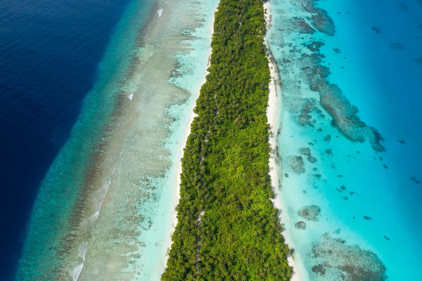 Dhigurah Island, Maldives - panoramic view of the long tropical island surrounded by crystal-clear ocean.